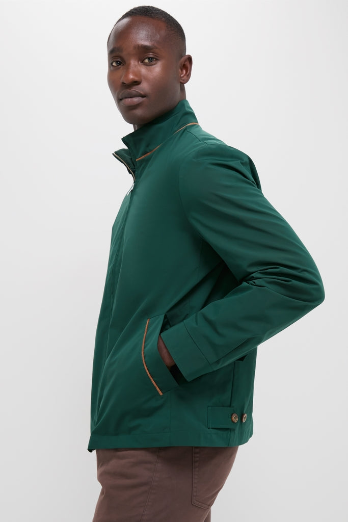 Man in profile wearing the classic Dark Green Stanley Jacket with suede-trimmed pockets, offering an effortless blend of high-end style and fun, modern comfort.