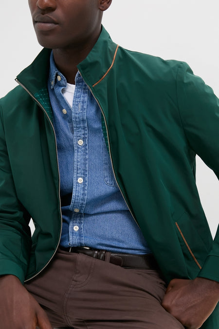 Man wearing the Dark Green Stanley Jacket over a denim shirt, featuring suede-trimmed pockets. The classic, high-end piece offers effortless style for any occasion.
