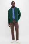 Man wearing classic Dark Green Stanley Jacket with suede-trimmed pockets, denim shirt, and brown trousers, exuding effortless, high-end style. Perfect for versatile, fun outings.