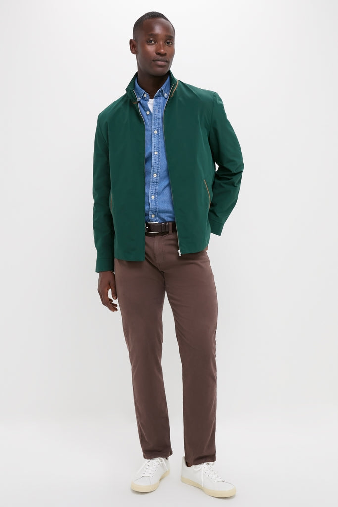 Man wearing classic Dark Green Stanley Jacket with suede-trimmed pockets, denim shirt, and brown trousers, exuding effortless, high-end style. Perfect for versatile, fun outings.