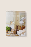 Cover of Artful Home by Josh Young, showcasing a classic, high-end living room with an effortless, fun design style featuring a fireplace, sofa, and elegant decor.
