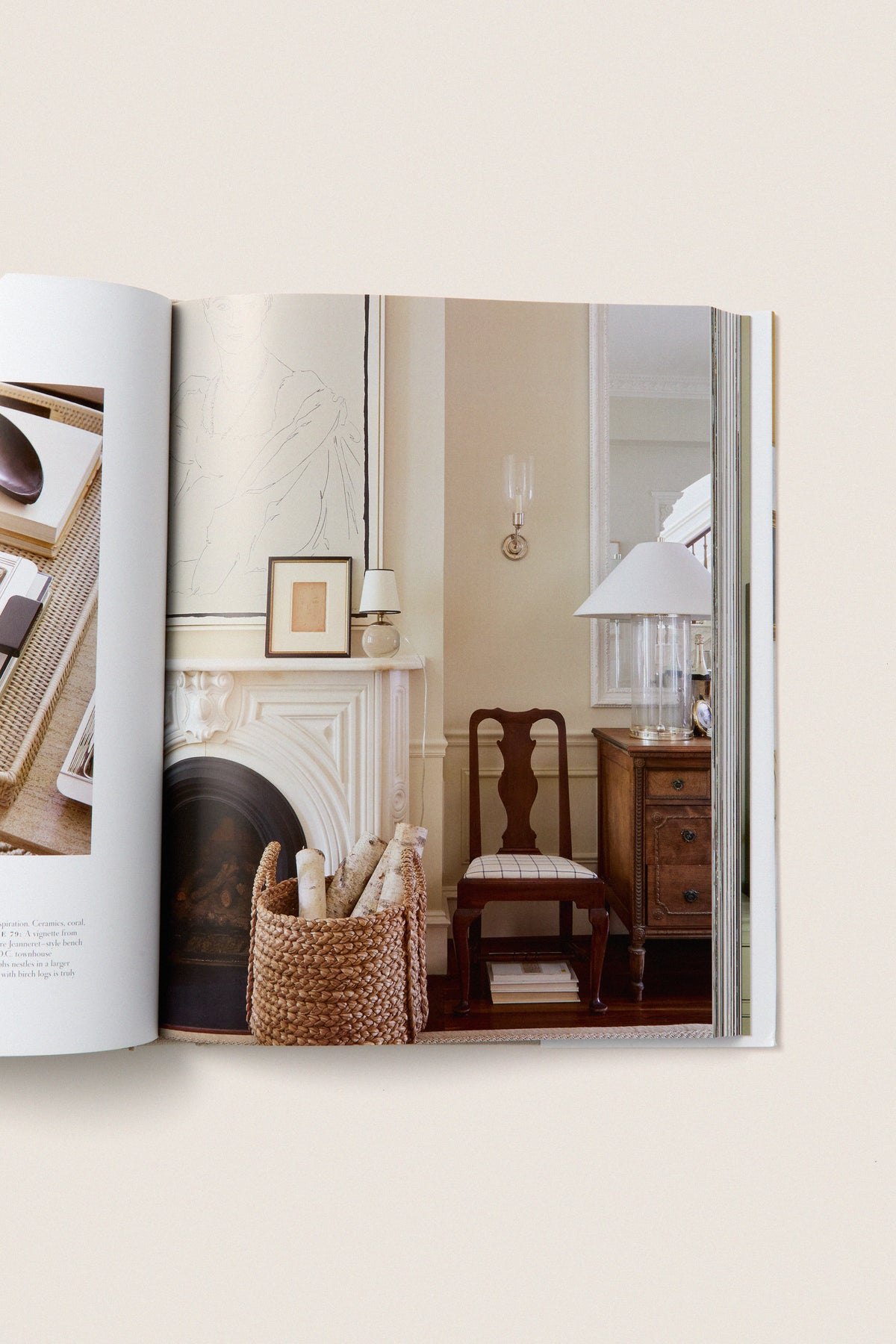 Artful Home open book showcases classic, effortless home decor with a marble mantel, wicker basket, and vintage furniture, embodying high-end design principles like palette and texture.