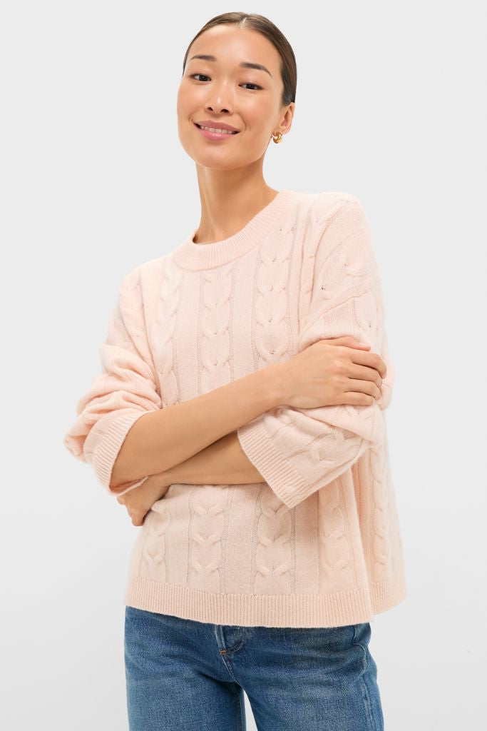 Soft Pink Cashmere Eloise Cable Knit Sweater, featuring classic cable patterns and a relaxed fit, effortlessly combines high-end comfort and fun style for a confident, chic look.