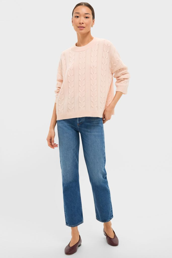 Model wearing classic Soft Pink Cashmere Eloise Cable Knit Sweater, showcasing an effortless, high-end style with crew neck, dropped shoulders, and boxy fit.