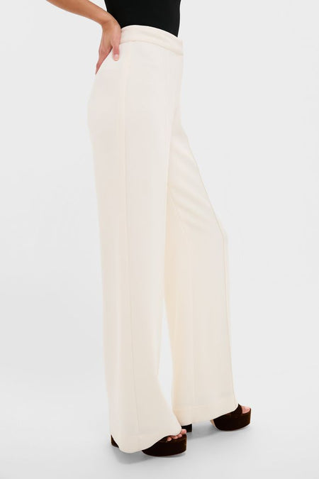 Model wearing Pearl White Crepe Versailles Pant, showcasing a classic high-waisted, wide-leg silhouette with effortless elegance, paired with dark brown platform sandals for a fun, high-end look.