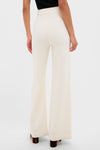 Pearl White Crepe Versailles Pant with classic wide-leg silhouette and high rise, showcasing effortless elegance and fun style, partially covering brown-heeled shoes from behind.