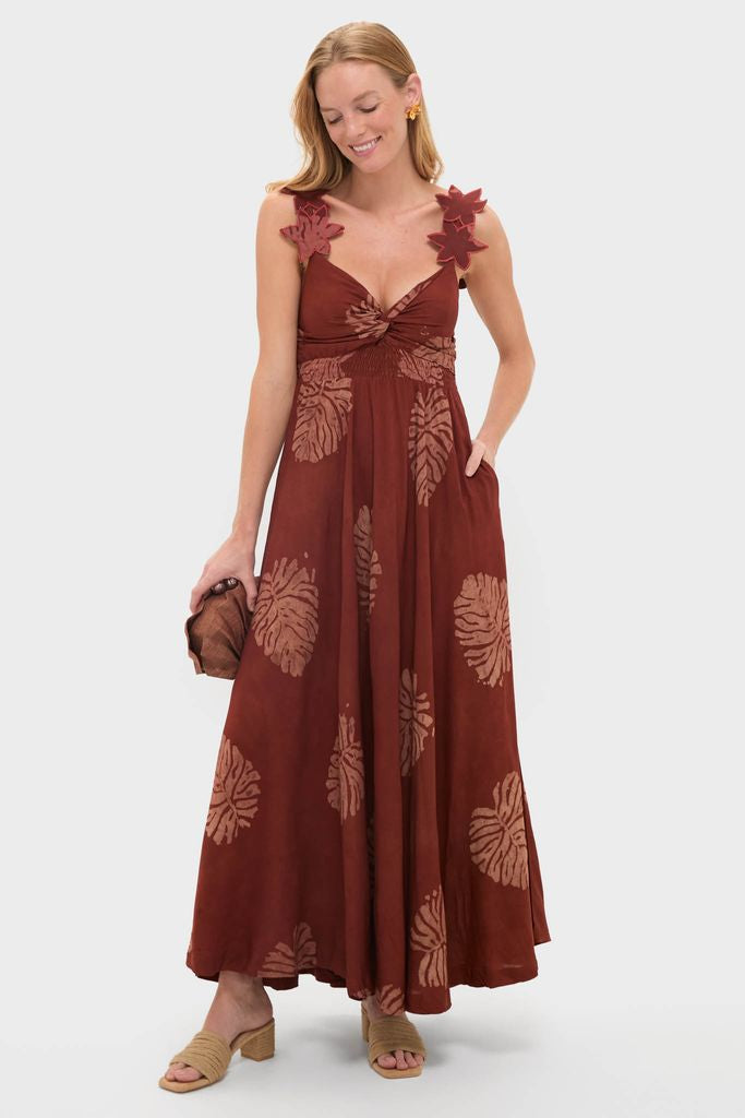 Model showcasing Natural Grenada Heels, featuring a classic braided upper and block heel, paired with an effortless rust sundress for a fun, high-end summer look.