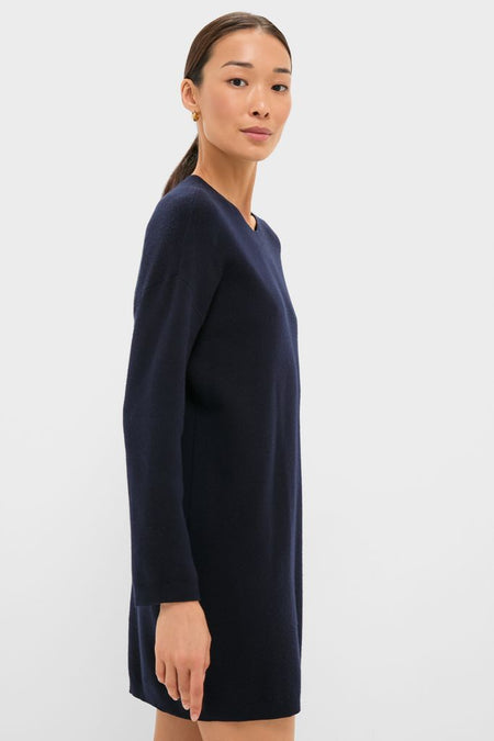 Woman models the Navy Vivianne Crewneck Dress, a classic, effortless tunic with drop shoulders and ribbed trim, perfect for fun, high-end transitional day-to-night wear.