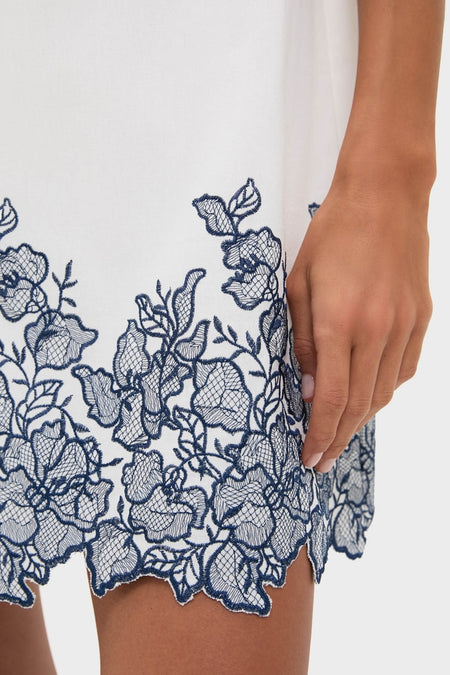 White & Navy Embroidery Mimi Mini Dress with classic navy floral lace hem, showcasing effortless style and high-end design through intricate, fun embroidery and playful detailing.