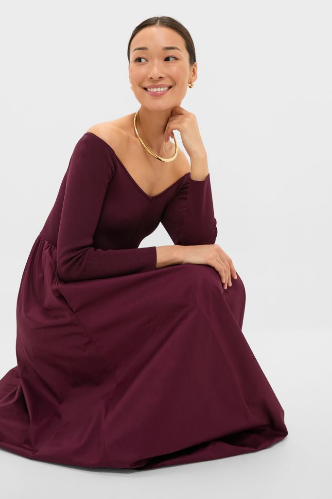 Young woman in the Winetasting Clea Dress, a classic, high-end, off-the-shoulder gown with a full skirt, exuding effortless elegance and fun sophistication.