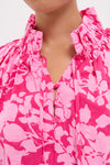 Pink Textured Floral Thea Blouse with high ruffle collar, neck-ties, and fabric-covered buttons, embodies classic, effortless elegance and fun, high-end style, perfect for springtime adventures.