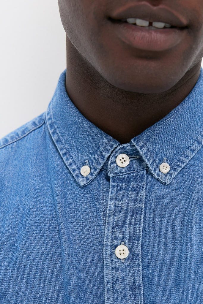 Classic Dark Indigo Washed Denim Shirt with a tab collar and white buttons, effortlessly styled for a high-end, fun, and versatile look.