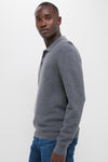 Classic Charcoal Merino Waffle Polo on a young man, effortlessly styled with jeans. This high-end, fun piece offers a timeless look and ultimate comfort.