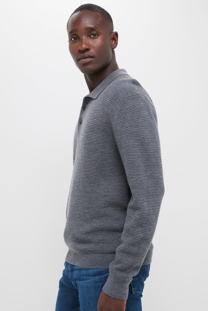 Classic Charcoal Merino Waffle Polo on a young man, effortlessly styled with jeans. This high-end, fun piece offers a timeless look and ultimate comfort.