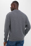 Person in a classic, effortless Charcoal Merino Waffle Polo sweater and jeans, showcasing high-end, fun style with waffle-knit texture and ribbed finishes.