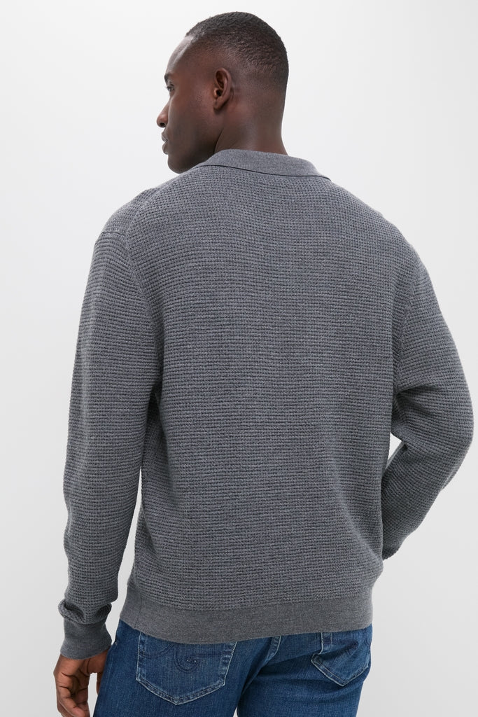 Person in a classic, effortless Charcoal Merino Waffle Polo sweater and jeans, showcasing high-end, fun style with waffle-knit texture and ribbed finishes.