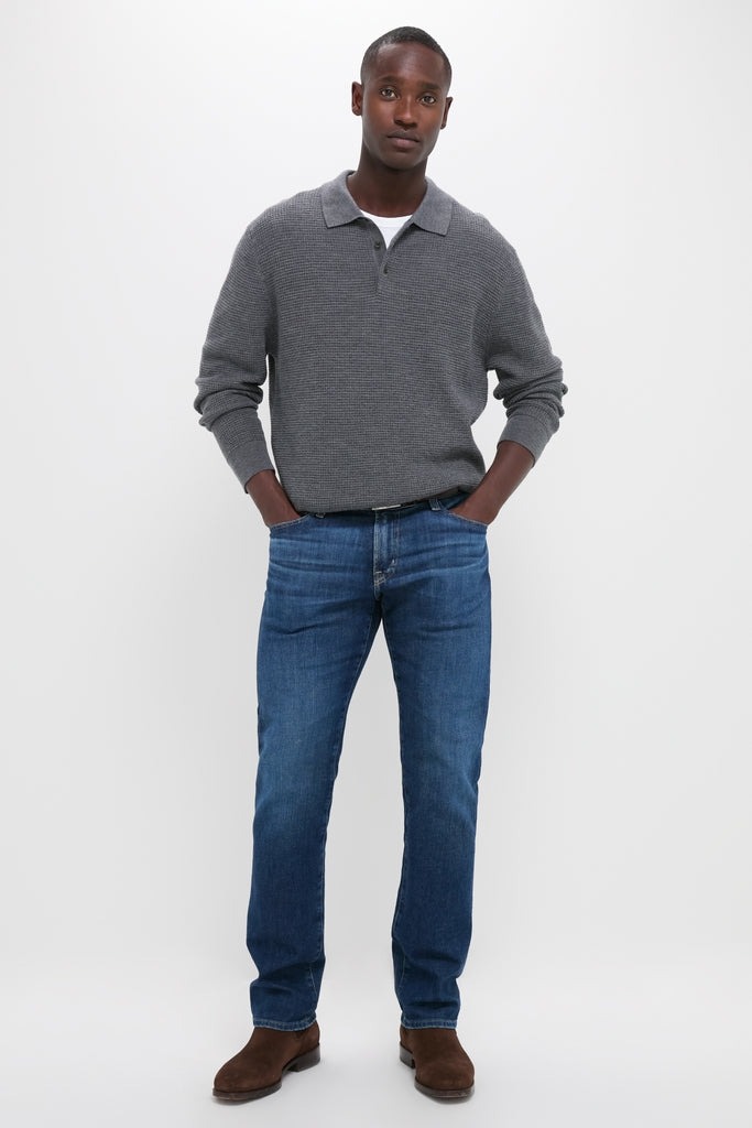 Model in Charcoal Merino Waffle Polo, a classic, high-end sweater, effortlessly paired with jeans and Chelsea boots, embodying Tuckernuck's fun, confident style.