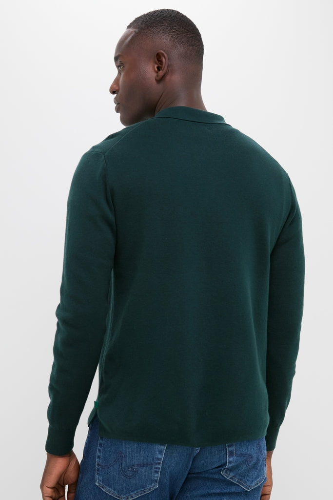 Man wearing Forest Green Merino Cardigan with a spread point collar and patch pocket, pairing classic style with effortless comfort in a fun, high-end look.