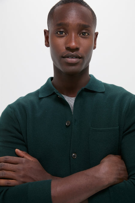 Young man wearing the classic Forest Green Merino Cardigan, an effortless blend of shirt and sweater, perfect for a high-end, fun, and versatile style.