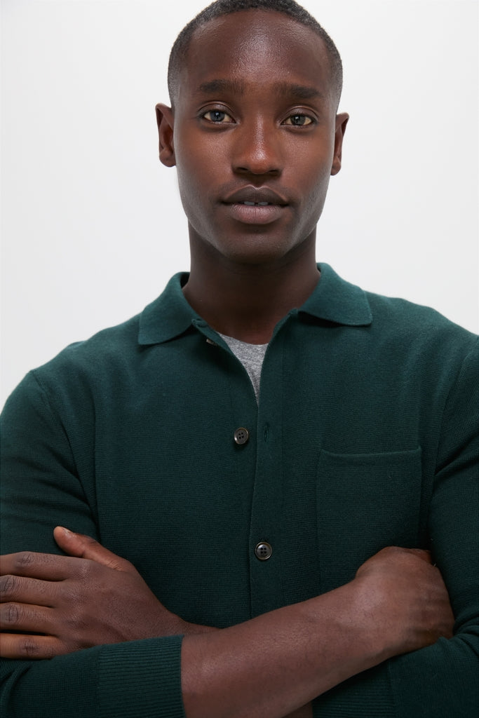 Young man wearing the classic Forest Green Merino Cardigan, an effortless blend of shirt and sweater, perfect for a high-end, fun, and versatile style.