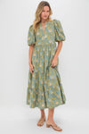 Woman models the Blue & Green Leafy Floral Cisco Maxi Dress, showcasing classic, effortless elegance with puff sleeves and a flowing, tiered A-line skirt.