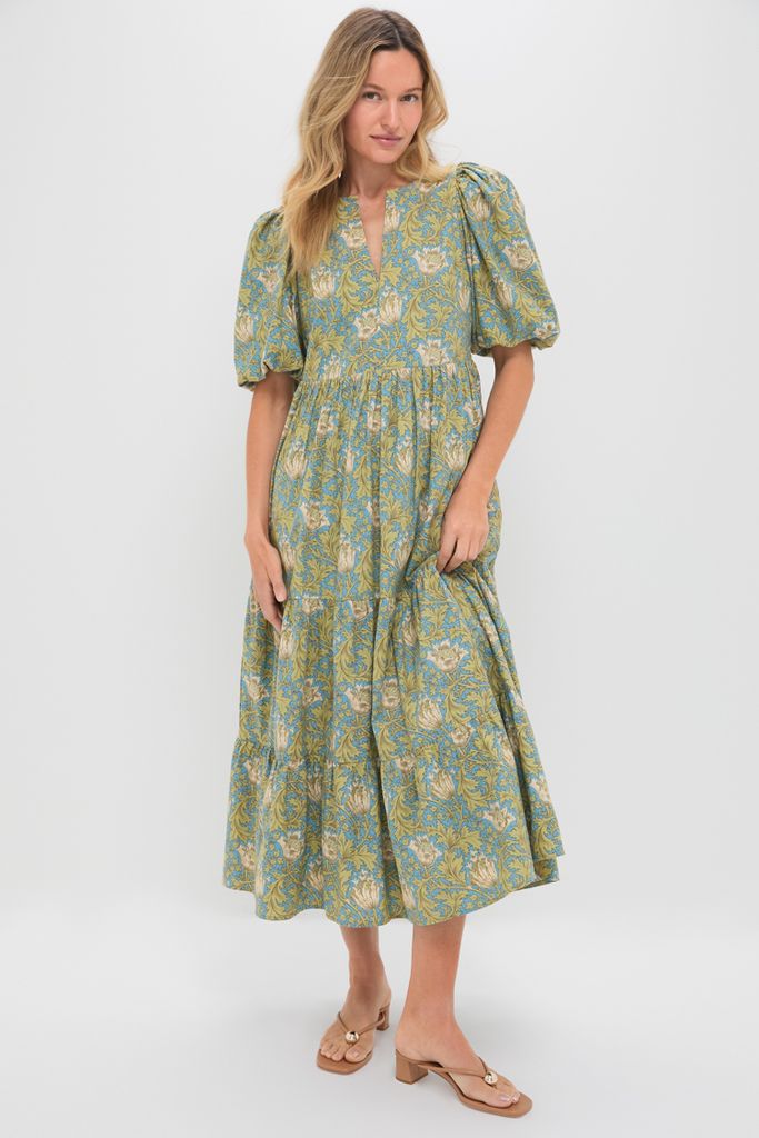 Woman models the Blue & Green Leafy Floral Cisco Maxi Dress, showcasing classic, effortless elegance with puff sleeves and a flowing, tiered A-line skirt.