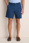 Person wearing Washed Navy Crown Comfort Short, showcasing its classic mid-length style. Paired with brown boat shoes, the look exudes effortless, high-end comfort.