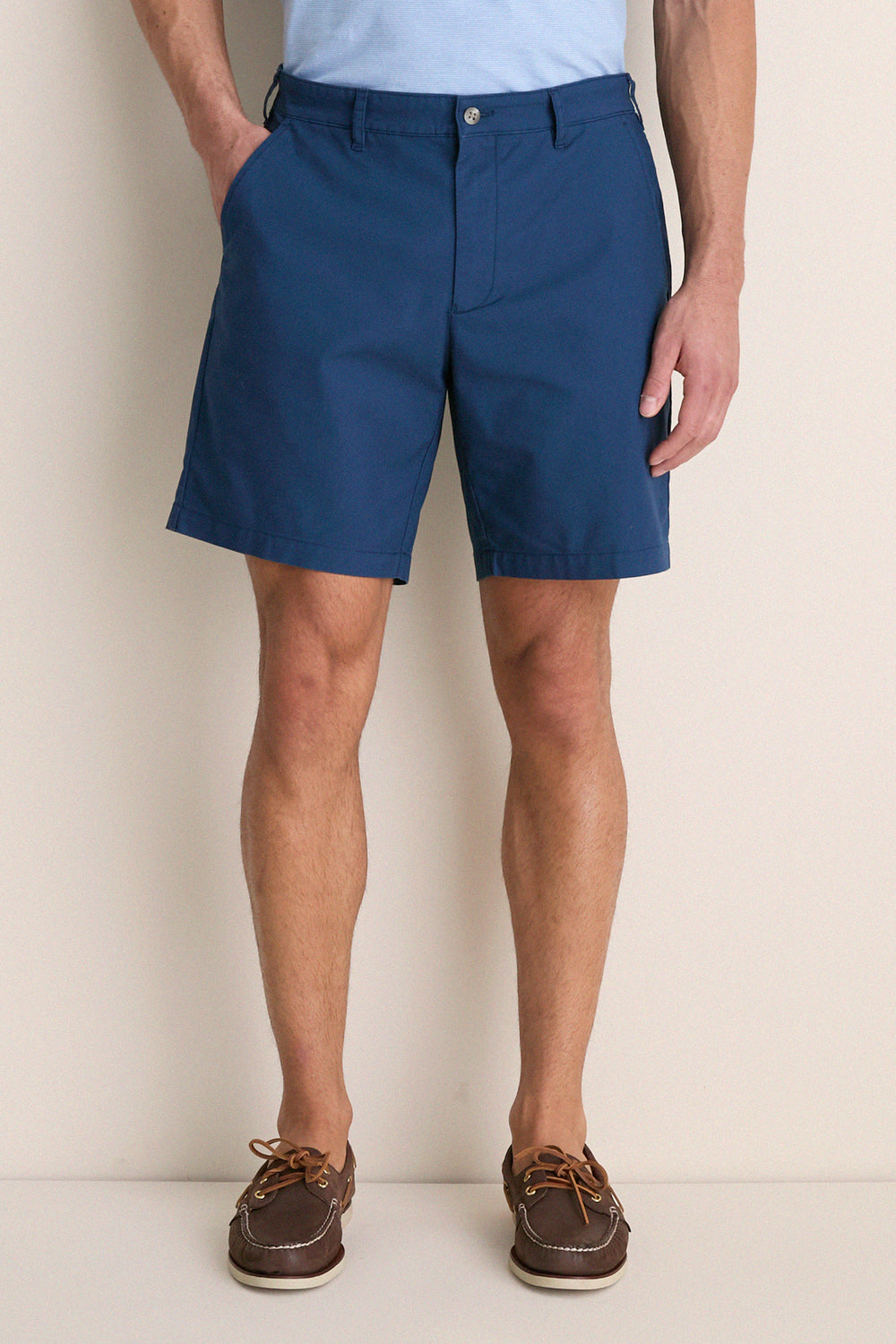 Person wearing Washed Navy Crown Comfort Short, showcasing its classic mid-length style. Paired with brown boat shoes, the look exudes effortless, high-end comfort.