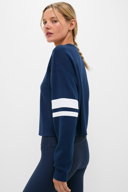 Model in the Navy Varsity Comfort Stretch Matilda Pullover, featuring classic drop shoulders and effortless stripes, paired with matching leggings for a fun, high-end look.