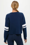 Back view of a person in a classic Navy Varsity Comfort Stretch Matilda Pullover, showcasing its effortless, fun, and high-end design with relaxed fit and drop shoulders.