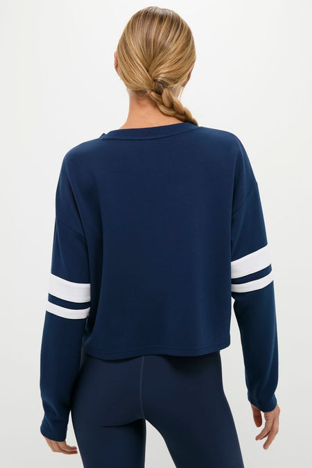 Back view of a person in a classic Navy Varsity Comfort Stretch Matilda Pullover, showcasing its effortless, fun, and high-end design with relaxed fit and drop shoulders.