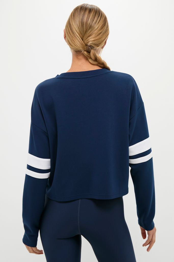 Back view of a person in a classic Navy Varsity Comfort Stretch Matilda Pullover, showcasing its effortless, fun, and high-end design with relaxed fit and drop shoulders.