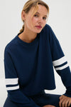 Young woman models the classic Navy Varsity Comfort Stretch Matilda Pullover, showcasing its effortless, fun style with drop shoulders and a relaxed, high-end fit.