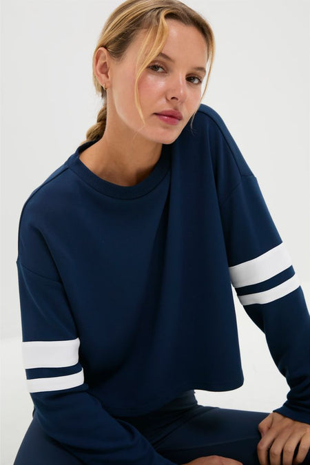 Young woman models the classic Navy Varsity Comfort Stretch Matilda Pullover, showcasing its effortless, fun style with drop shoulders and a relaxed, high-end fit.