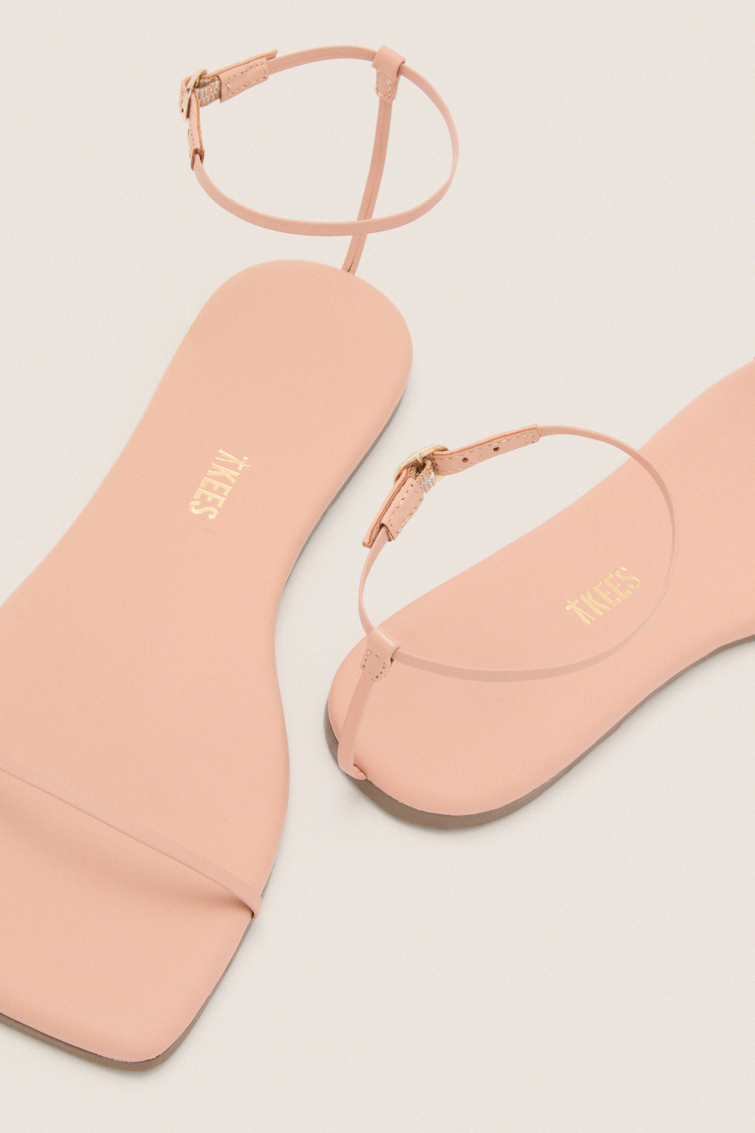 Nude Beach Square Toe Twiggy Sandals featuring a classic, effortless thong design with thin ankle straps and gold buckles. Perfect for a high-end, fun summer style.