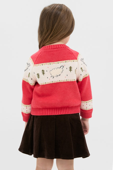 Young girl in a classic Red Lamb Sweater with sheep motifs and button front, paired with a flared skirt, embodying effortless, high-end, fun style.