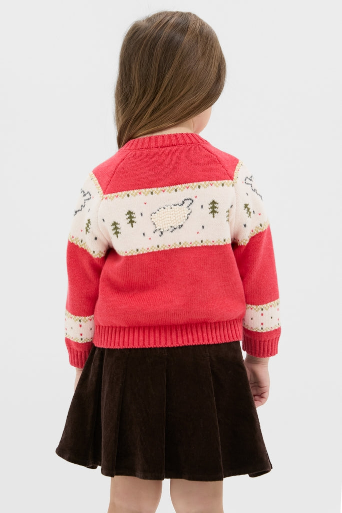 Young girl in a classic Red Lamb Sweater with sheep motifs and button front, paired with a flared skirt, embodying effortless, high-end, fun style.