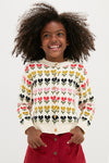 Young girl joyfully models the classic Multi Floral Sweater, featuring tulip motifs. This high-end, effortless cardigan embodies fun and style, perfect for little explorers.