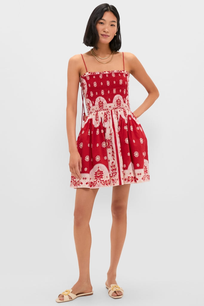 Merida Lava Bandana Dress: Classic sleeveless mini with smocked bodice, tasseled ties, and a flouncy skirt, paired with cream slide sandals for an effortless, high-end look.