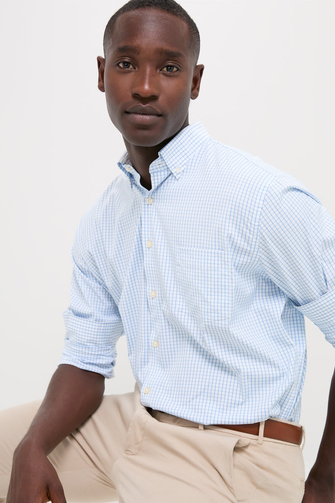 Young man in the classic Cottage Blue Hanford Performance Twill Sport Shirt, effortlessly styled with light khakis, epitomizing high-end, fun sophistication and functional elegance.