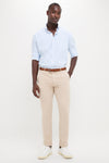 Black man in light blue Cottage Blue Hanford Performance Twill Sport Shirt, embodying classic, effortless style with high-end, functional features like moisture-wicking and sun protection, paired with khaki chinos.