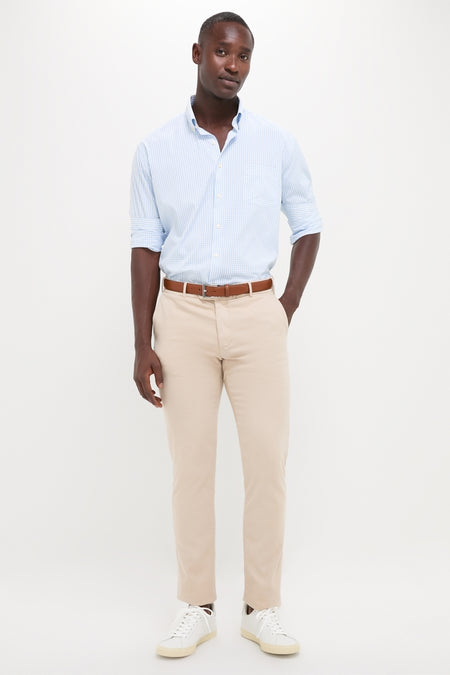 Black man in light blue Cottage Blue Hanford Performance Twill Sport Shirt, embodying classic, effortless style with high-end, functional features like moisture-wicking and sun protection, paired with khaki chinos.