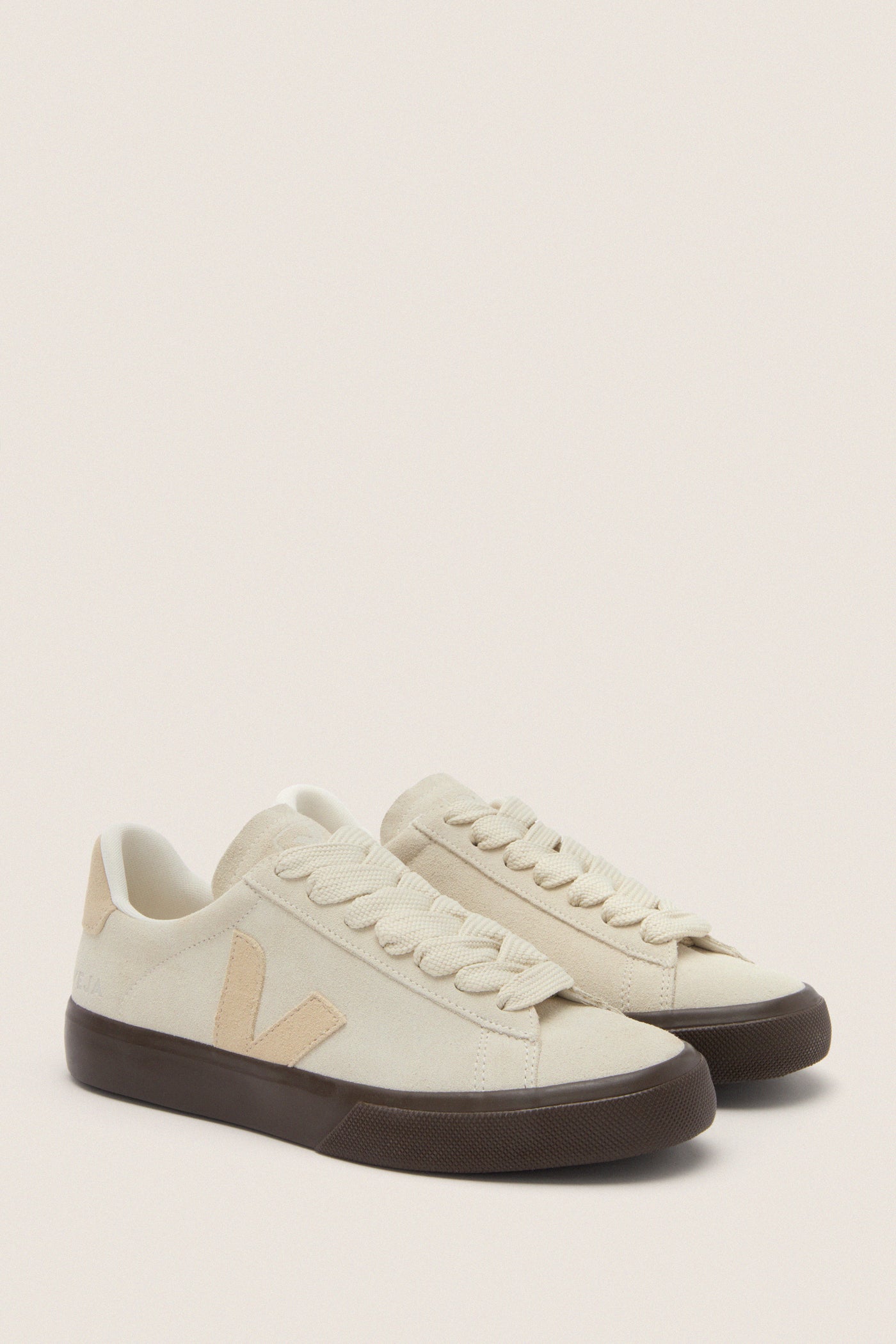 Pierre Almond Eagle Campo Bold Sneakers in off-white suede with dark brown soles, featuring a classic Veja V logo. Effortless and fun, perfect for high-end casual wear.