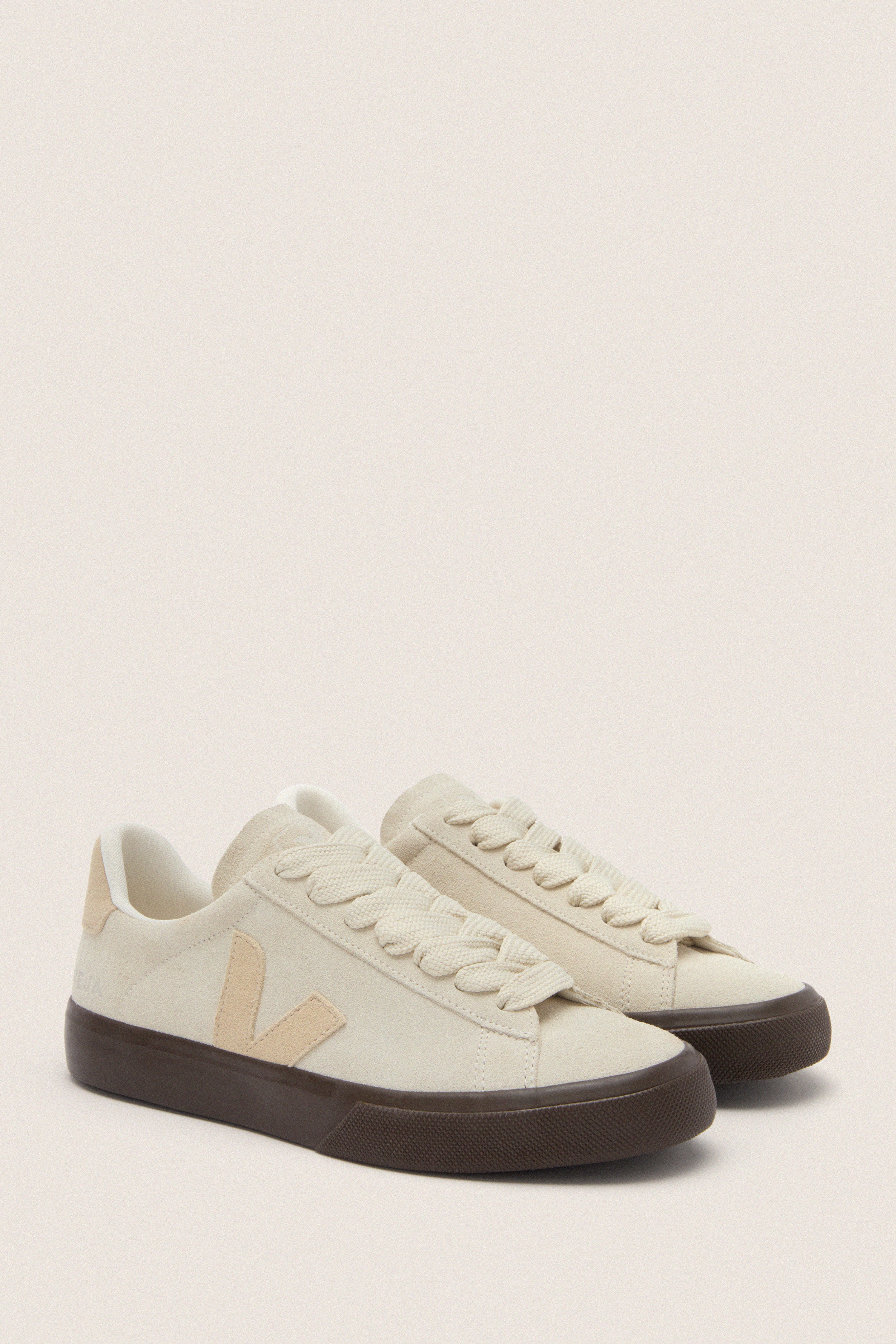 Pierre Almond Eagle Campo Bold Sneakers in off-white suede with dark brown soles, featuring a classic Veja V logo. Effortless and fun, perfect for high-end casual wear.
