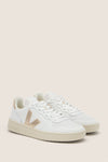 Extra White Platine V-10 Sneakers: Classic low-top white leather sneakers with perforated details, metallic gold V logo, and an off-white sole for an effortless, high-end look.