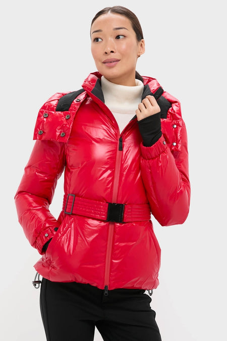 Woman modeling the classic Red Candice Ski Parka, showcasing its effortless, high-end design with a built-in belt, quilted texture, and practical ski-ready features.