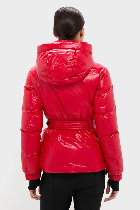 Back view of a person in a classic Red Candice Ski Parka with a hood, belted waist, and quilted design. Effortless, high-end winter wear for fun on the slopes.