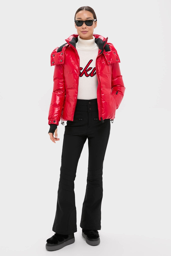 Model wearing the classic Red Candice Ski Parka, effortlessly blending high-end style with fun, featuring a glossy finish, detachable hood, and functional ski-ready details.