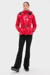 Model in Red Candice Ski Parka showcasing classic, high-end style with effortless elegance; features include a belted waist and helmet-compatible hood for fun, versatile mountain-ready fashion.