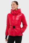 Model wearing the classic, high-end Red Candice Ski Parka with a wide belt, showcasing its effortless, streamlined style and fun, practical features for alpine adventures.